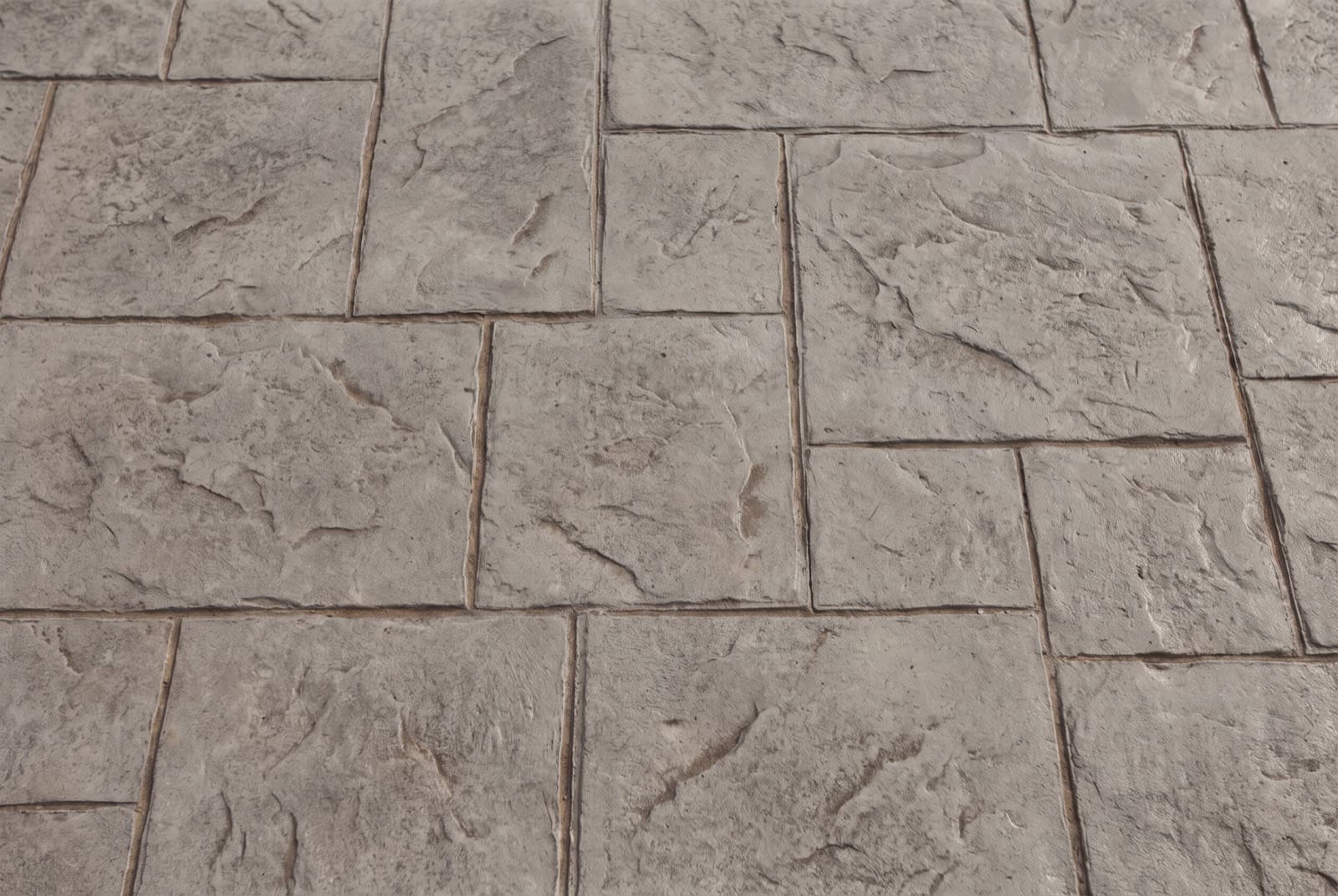 Overhead view of stamped concrete in an ashlar slate pattern with integral color